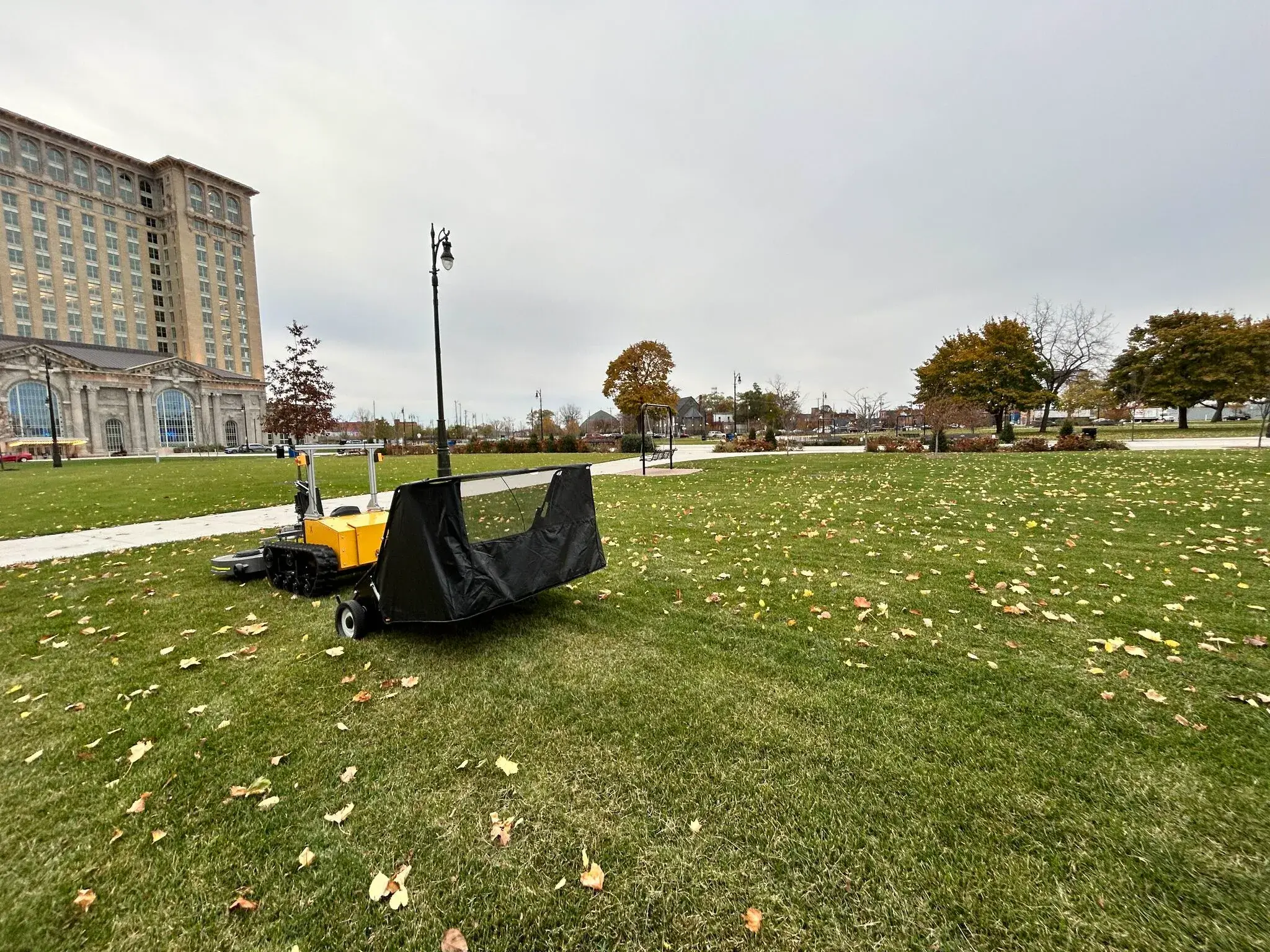 A Snowbotix SMUR unit working a campus lawn during all-season grounds and sweeping work.